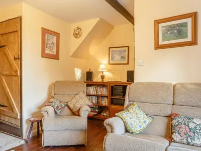 a living room with a couch and two chairs at Pen Y Crug in Beulah