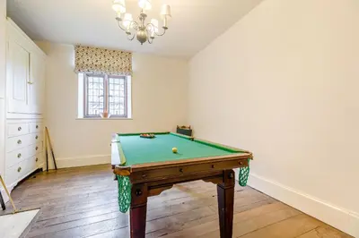 a living room with a pool table in it at The Generals Quarters at Pitchford Estate in Shrewsbury