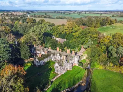an aerial view of a mansion in the countryside at The Generals Quarters at Pitchford Estate in Shrewsbury
