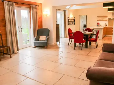 a living room with a table and chairs at Treehouse Barn at Pitchford Estate in Shrewsbury