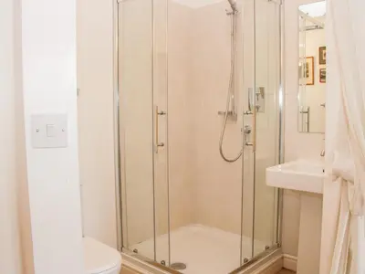 a bathroom with a shower and a toilet and a sink at Treehouse Barn at Pitchford Estate in Shrewsbury