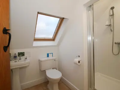 a bathroom with a toilet and a sink and a window at Windy Mundy Farm at Pitchford Estate in Shrewsbury