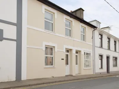 a white building on the side of a street at Bristol House in New Quay