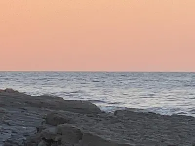 a beach with the ocean in the background at Bristol House in New Quay
