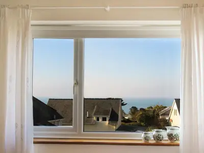 a window with a view of the ocean at Garnedd Lwyd in Harlech