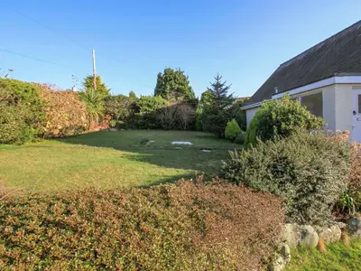a yard of a house with a large lawn at Garnedd Lwyd in Harlech