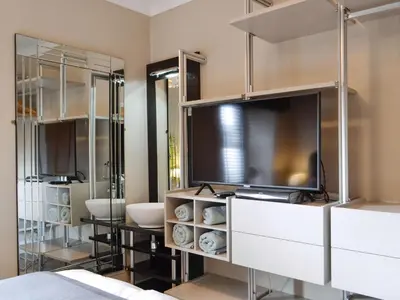 a room with a tv and a bathroom at The Apartment in Brecon