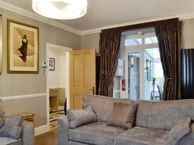 a living room with a couch and a window at The Apartment in Brecon