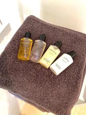 a group of four bottles of hair products on a carpet at Wisteria Cottages are self catering cottages in a beautiful village location in Dorrington