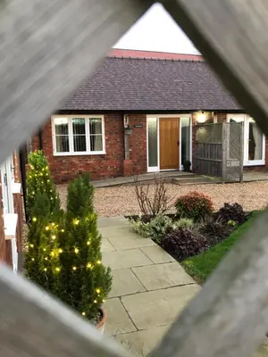 a house with a christmas tree in the front yard at Wisteria Cottages are self catering cottages in a beautiful village location in Dorrington