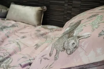 a pink bed with a rabbit on it at The Fox Den in Rhayader