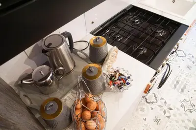 a kitchen counter with a stove top with a basket of eggs at Woodland Escape in Nantmel