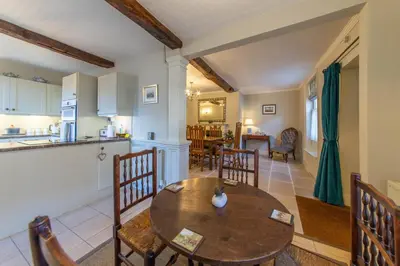 a kitchen and living room with a wooden table and chairs at Turford House, Ludlow in Ludlow
