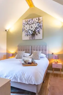 a bedroom with a bed with a tray on it at The Patches in Shrewsbury