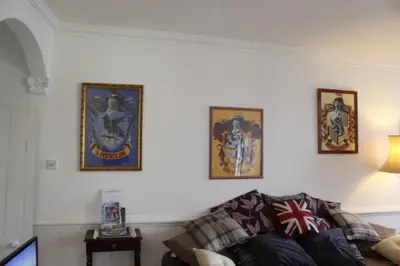 a living room with a couch and pictures on the wall at 4BedHouse Leominster Hiking Castles Sleeps7 Wifi in Leominster