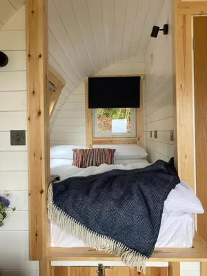 a bedroom with two beds and a window at Cefn Crib Cabins in Machynlleth
