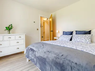 a bedroom with a large bed and a white dresser at Barn Owls Rest in Clyro