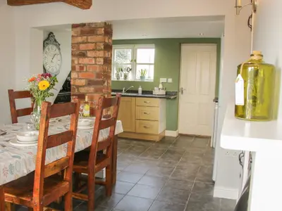 a kitchen and dining room with a table and chairs at 1 Royal Oak Cottages in Shrewsbury