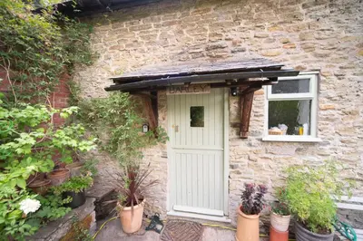 a brick house with a white door and a window at Lower House B&B and Cottages, Adforton in Leintwardine