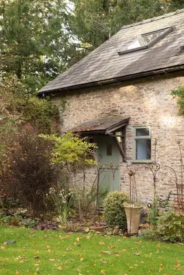a brick house with a door and a window at Lower House B&B and Cottages, Adforton in Leintwardine