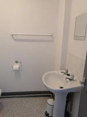 a white bathroom with a sink and a toilet at Ty'r Bont Studios in Newtown