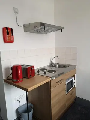 a small kitchen with a sink and a microwave at Ty'r Bont Studios in Newtown