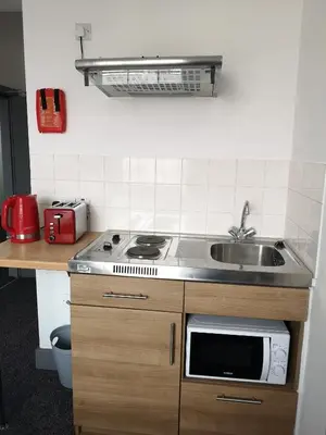 a kitchen with a stove and a sink at Ty'r Bont Studios in Newtown