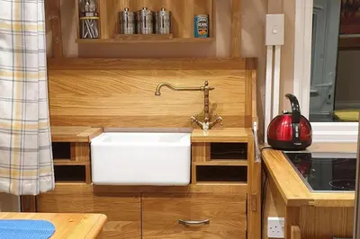 a kitchen with a white sink in a kitchen at Riverside Cabin - Sleeps 2 - HotTub - Parking in Oswestry