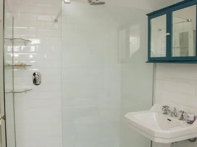 a white bathroom with a sink and a mirror at Willow View in Shrewsbury