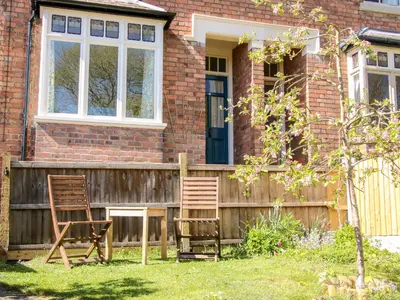 two chairs sitting outside of a house at Willow View in Shrewsbury