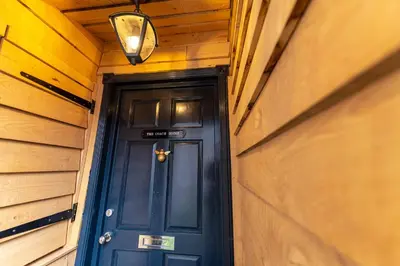 a blue door in a house with a light above it at Coach House, Shrewsbury Town in Shrewsbury