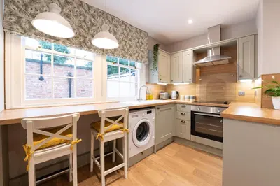 a kitchen with a washer and dryer at Coach House, Shrewsbury Town in Shrewsbury