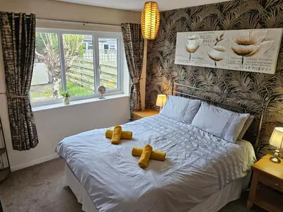 a bedroom with a bed with two teddy bears on it at Ridge And Tides in Fairbourne