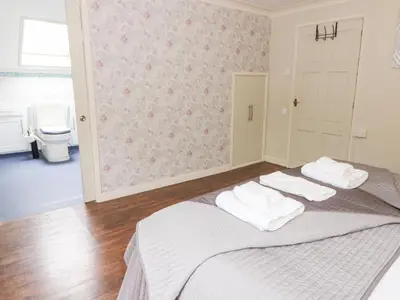 a bedroom with a bed with white towels on it at Tynewydd Fields in Lampeter