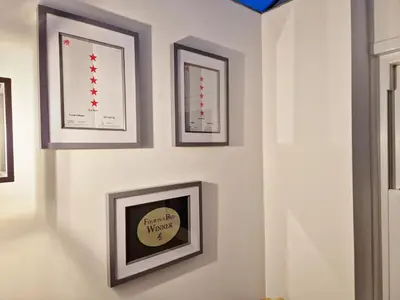 a wall with four framed pictures on a wall at Llys Bach Apartment at Llys Aeron in Aberaeron