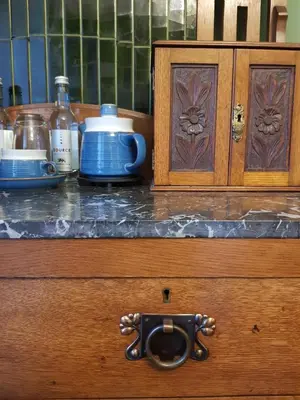 a wooden counter top with a cupboard with a handle at Afallon Townhouse in Dolgellau
