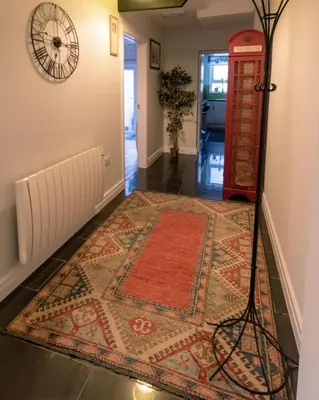 a hallway with a red phone booth and a rug at No 31 Promenade APARTMENT by the sea in Aberystwyth