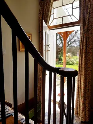 a stairway with a glass door leading to a porch at Upper Buckton B&B in Leintwardine