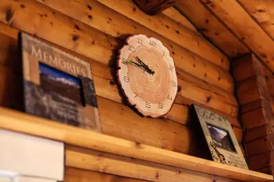 a clock on the side of a wooden wall at Stunning Log Cabin with Garden in Snowdonia - Hosted by Seren Short Stays in Trawsfynydd