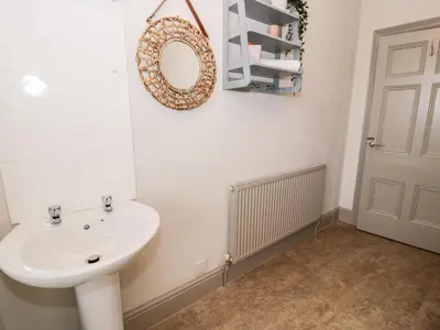 a bathroom with a sink and a mirror on the wall at Rose Suite in Barmouth