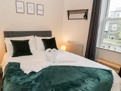 two swans made out of towels on a bed at Emerald Suite in Barmouth