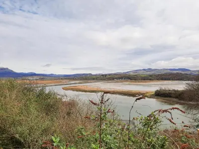 a view of a river with mountains in the background at Sapphire Suite in Barmouth