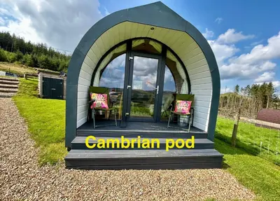 a gazebo with a table and chairs in it at Forester's Retreat Glamping - Cambrian View- Vaccinated dogs over the age of 2 are accepted in Aberystwyth