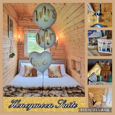 a room with a bed with balloons in the shape of a heart at Forester's Retreat Glamping - Cambrian View- Vaccinated dogs over the age of 2 are accepted in Aberystwyth