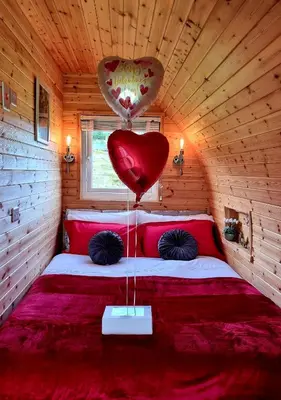 a room with a bed with a heart balloon on it at Forester's Retreat Glamping - Cambrian View- Vaccinated dogs over the age of 2 are accepted in Aberystwyth