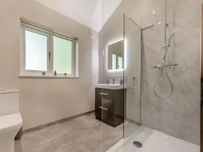a bathroom with a shower and a toilet and a sink at Dwrgi - Uk32923 in Cwrt-newydd