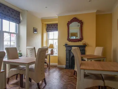 a dining room with a table and chairs and a mirror at Riverbank Bed and Breakfast in Llanwrtyd Wells
