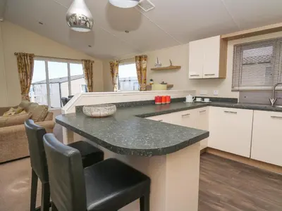 a kitchen with a large island in a room at The Potting Shed in New Quay