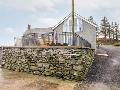 a stone wall in front of a house at Hen Dy Bryn Mawndy in Corwen