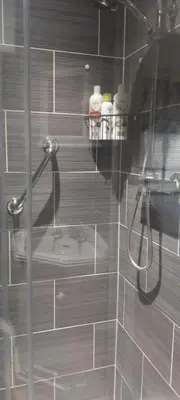 a bathroom with a shower with a glass door at 2 Bodwen Villas in Llangollen
